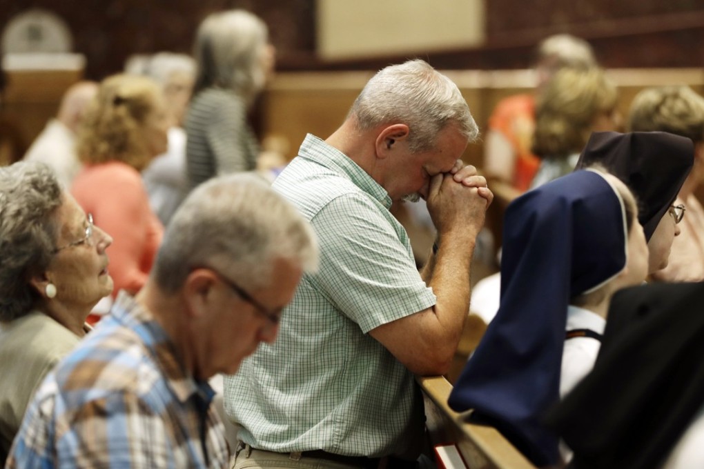 Parishioners pray before celebrating mass at the Cathedral Church of Saint Patrick in Harrisburg, Pennsylvania, on August 17. A grand jury released a report last week detailing seven decades of rampant sexual abuse affecting more than 1,000 children, by some 300 priests in six Pennsylvania dioceses. Photo: AP