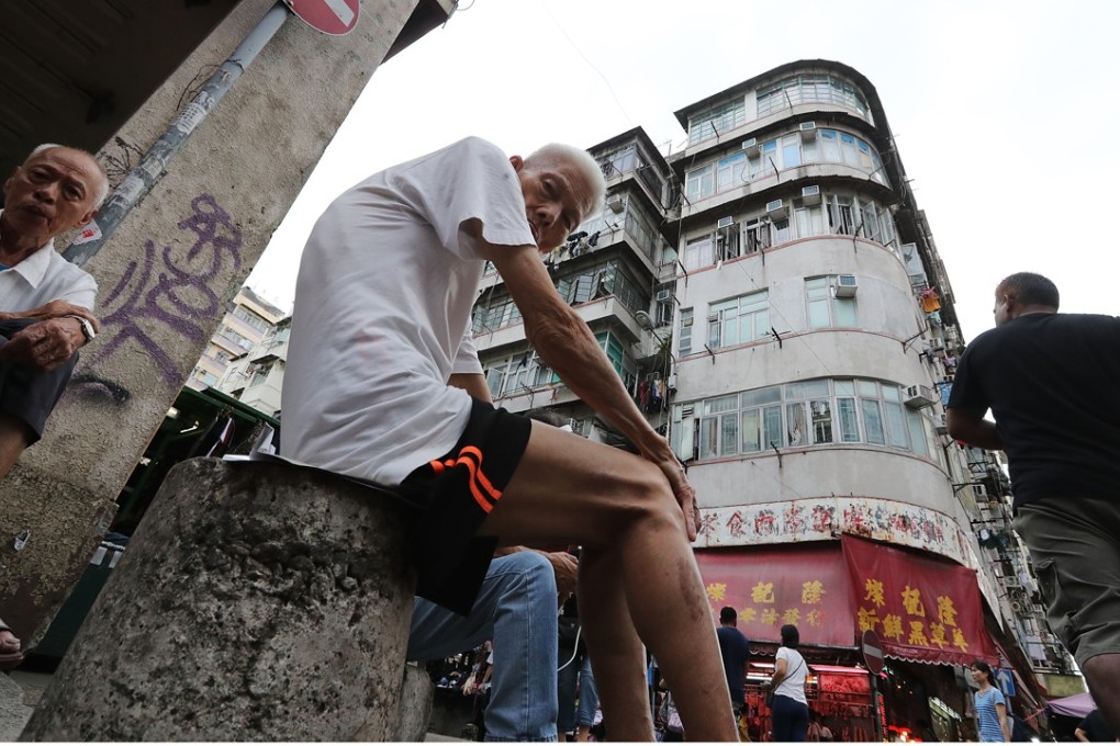 An elderly resident sits on the street in Sham Shui Po in Kowloon. Photo: Edward Wong