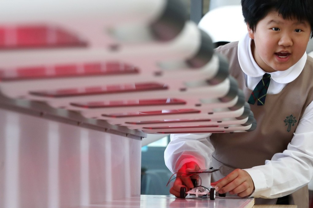A girl experiments with a solar car during a STEM promotional activity organised by the Education Bureau, at the SKH Holy Cross Primary School in Kowloon City on March 20. Photo: Nora Tam