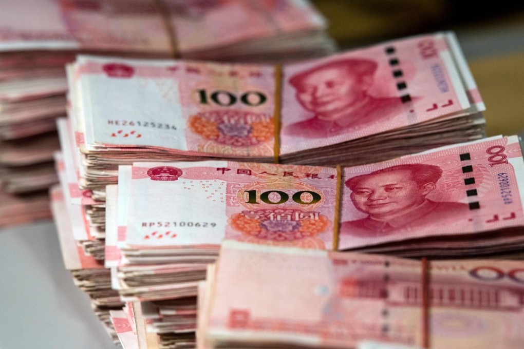 Bundles of 100 yuan notes are pictured at a bank in Shanghai on August 8. Photo: Agence France-Presse