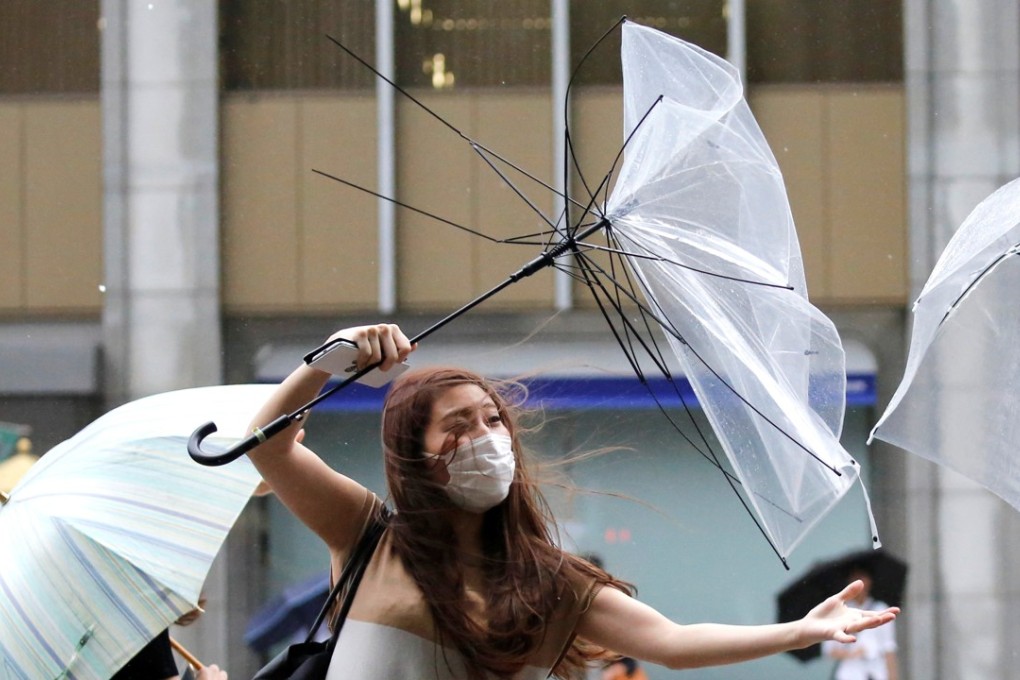 A woman struggles as a typhoon approaches Tokyo earlier this month. Photo: Reuters
