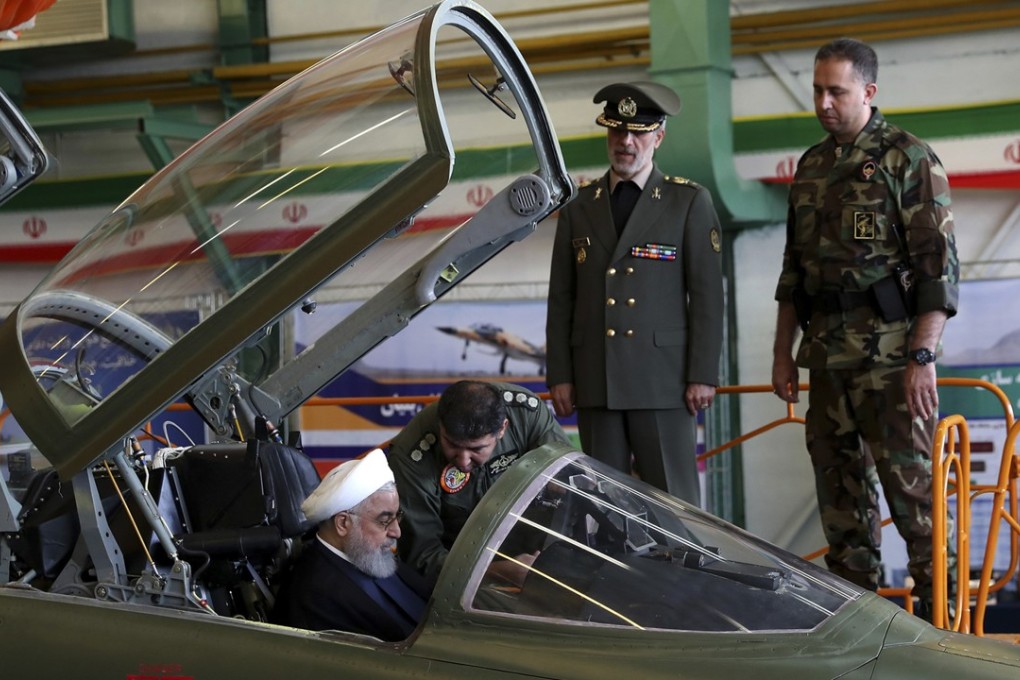 Iranian President Hassan Rowhani sitting in the cockpit of the fighter jet before the inauguration ceremony. Photo: AP