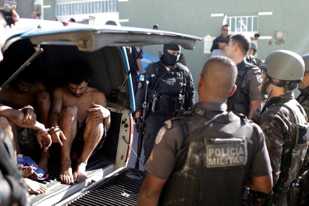 Suspects who allegedly took a family hostage are arrested after violent clashes with Brazilian Army soldiers in the Alemao slums of Rio de Janeiro, Brazil, on Monday. Photo: Reuters