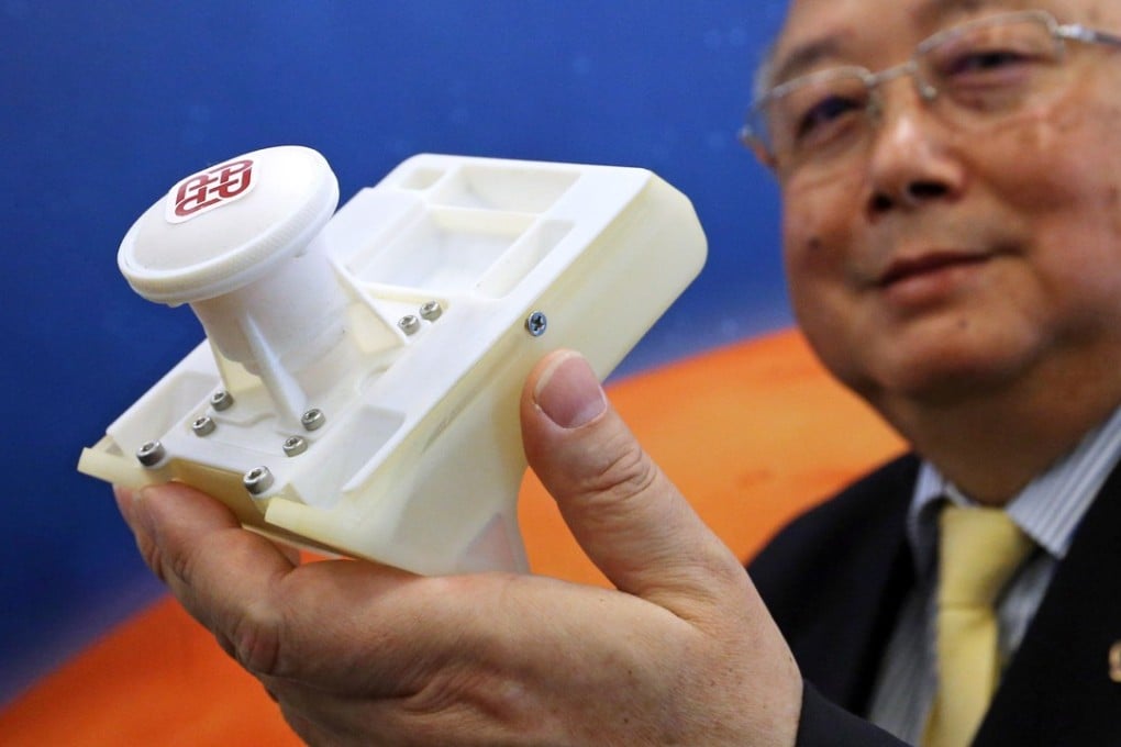 Professor Yung Kai-leung, the university’s chair professor of precision engineering, with a prototype of the camera on Wednesday. Photo: Dickson Lee