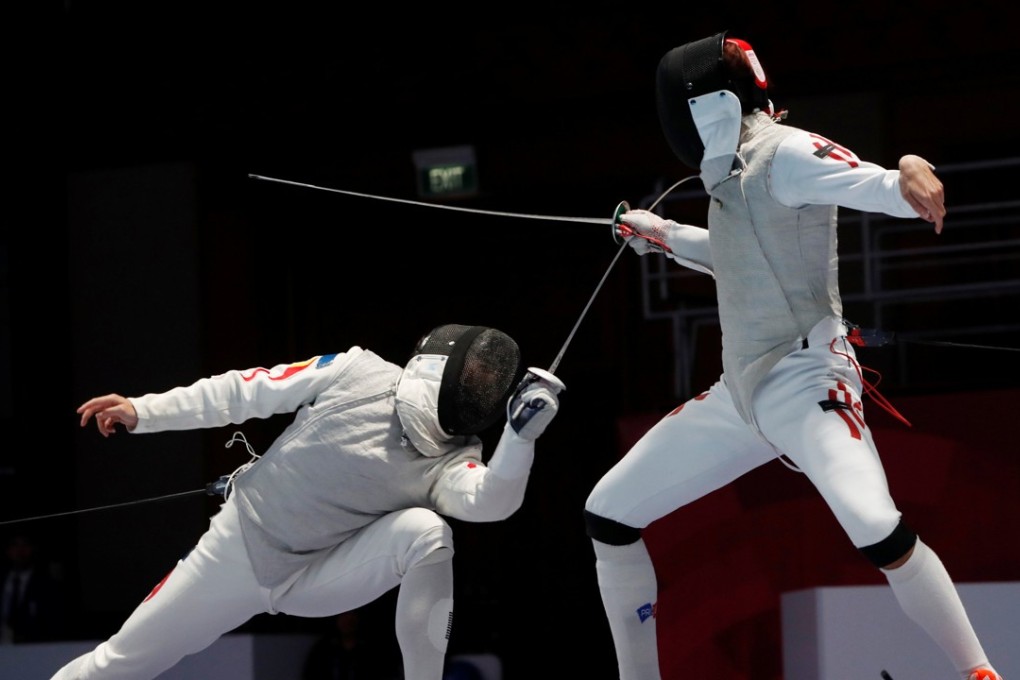 Huang Mengkai of China in action with Nicholas Choi of Hong Kong in the final of the men’s foil. Photo: Reuters