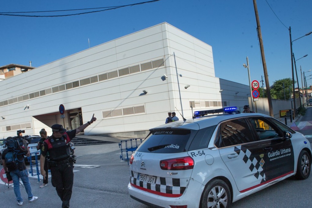 An officer gives direction outside a Catalan regional police station on Monday after the police fatally shot a man who entered in the building holding a knife and allegedly shouting 'Allah’. Photo: EPA-EFE