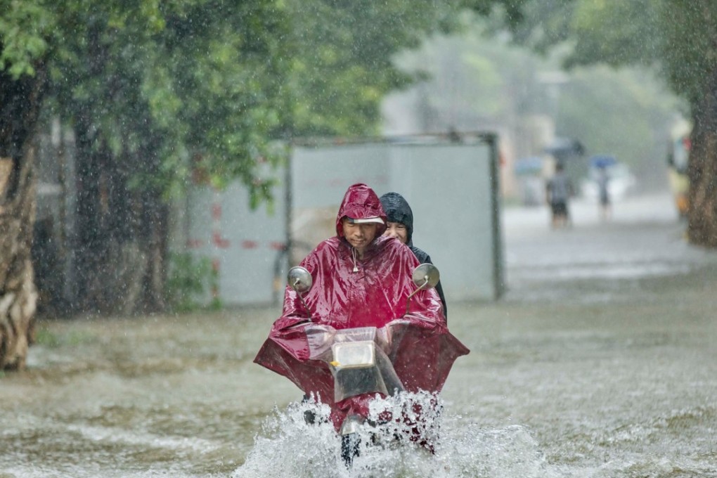 Heavy rains from Tropical Storm Ewiniar brought chaos to Guangzhou, China, on June 8. The high levels of corporate debt in China and other emerging markets have raised concerns that there is bad weather ahead for the global economy. Photo: Reuters.