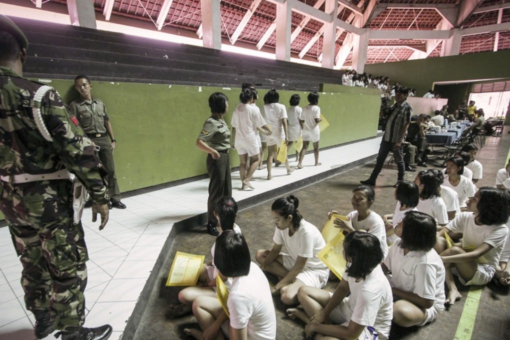 Female candidates for the Indonesian armed forces attending a medical check-up at the Diponegoro Military Command Headquarters in Semarang, Central Java, in 2014. The selection includes a virginity test. Photo: Alamy