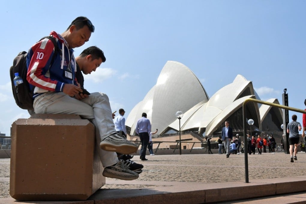 Tourists outside the Sydney Opera House. Photo: AFP