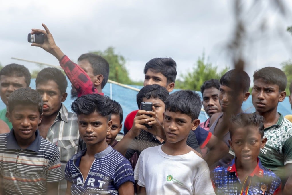 Rohingya refugees gather near the fence in the “no-man’s-land” zone between Myanmar and Bangladesh border. Photo: AFP
