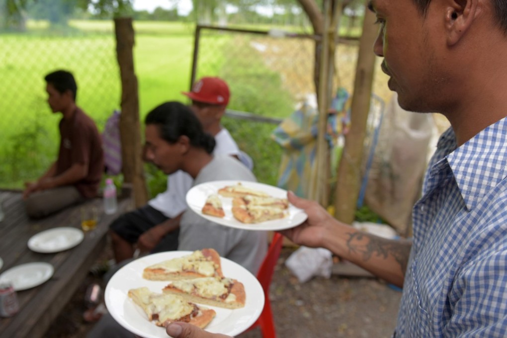 A little slice of America is served to refugees who were deported to Cambodia from the United States. Photo: AFP