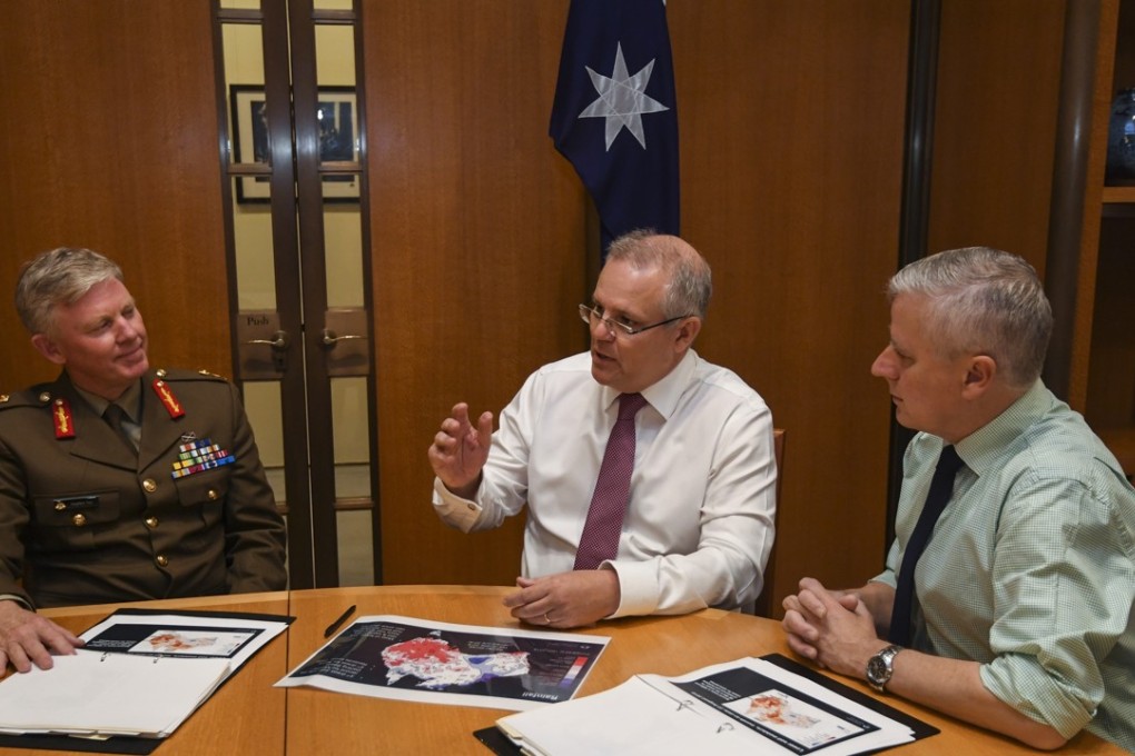 Australia’s latest leader, Scott Morrison (centre), spoke with President Donald Trump, organised his Cabinet and met drought-affected farmers on Saturday as the backlash continued over yet another prime minister selected by an internal party vote. Photo: EPA