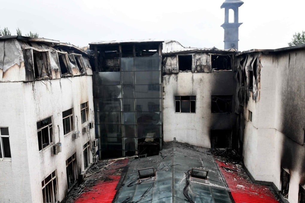 The blackened hotel building after the fire that killed 19 people on Saturday morning. Photo: Xinhua