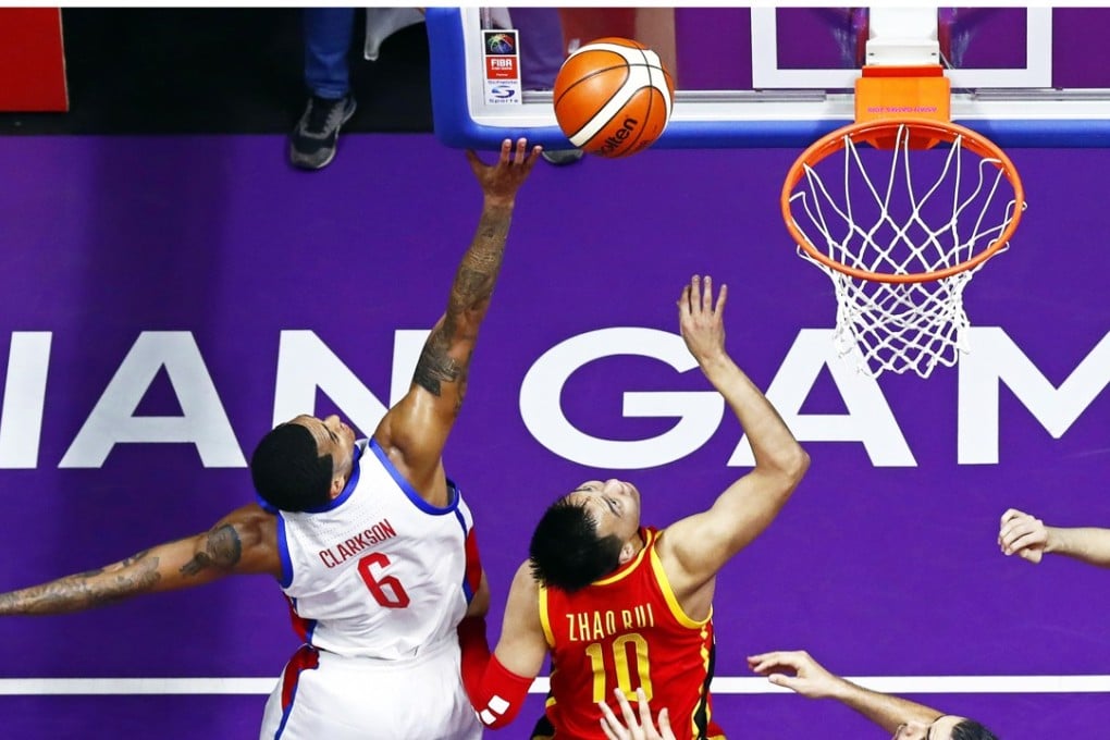 Jordan Clarkson (left) attempts a basket against China. Photo: EPA