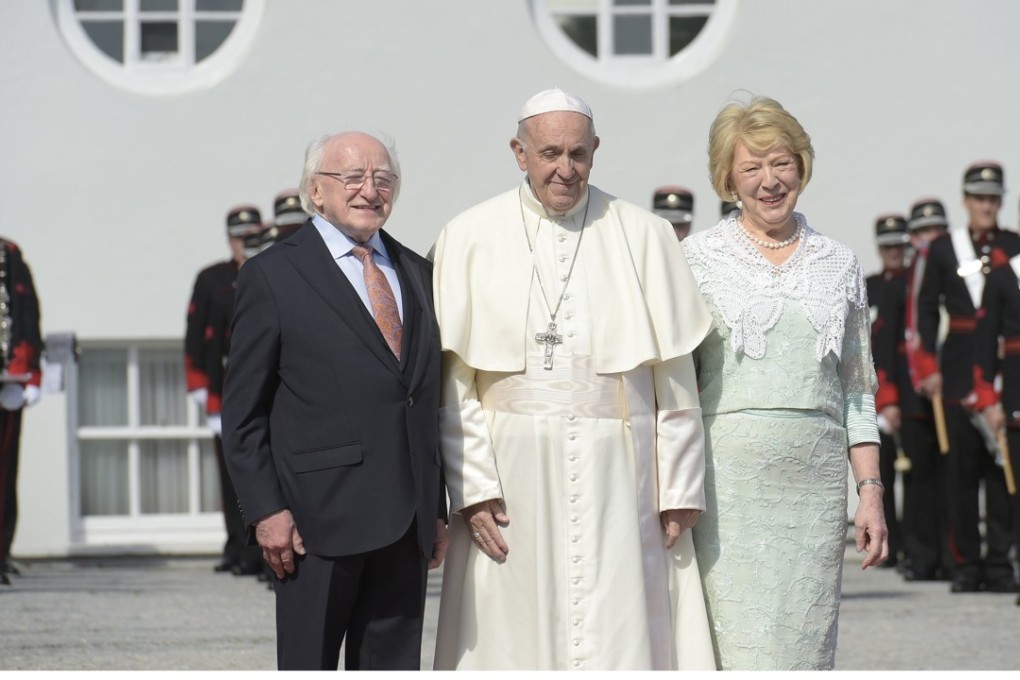 Pope Francis poses next to Ireland's President Michael Higgins and his wife Sabina Coyne during his visit in Dublin. Photo: Reuters
