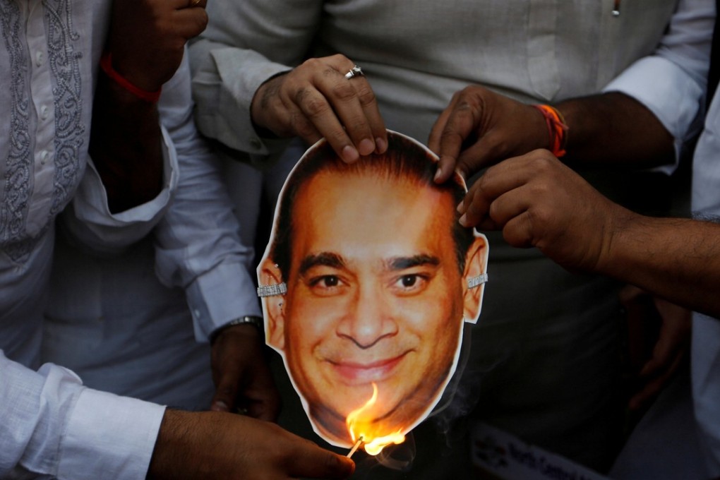 Congress party activists burn an image of billionaire jeweller Nirav Modi. Photo: Reuters