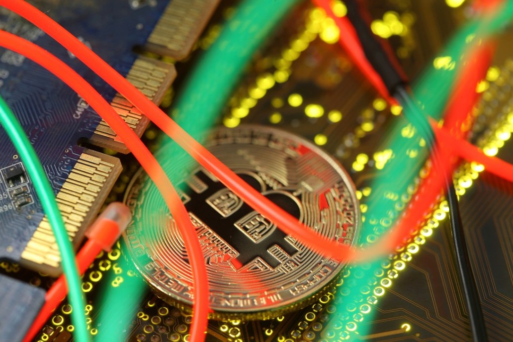 FILE PHOTO: Representation of the bitcoin virtual currency standing on the PC motherboard is seen in this illustration picture, February 3, 2018. REUTERS/Dado Ruvic/Illustration/File Photo