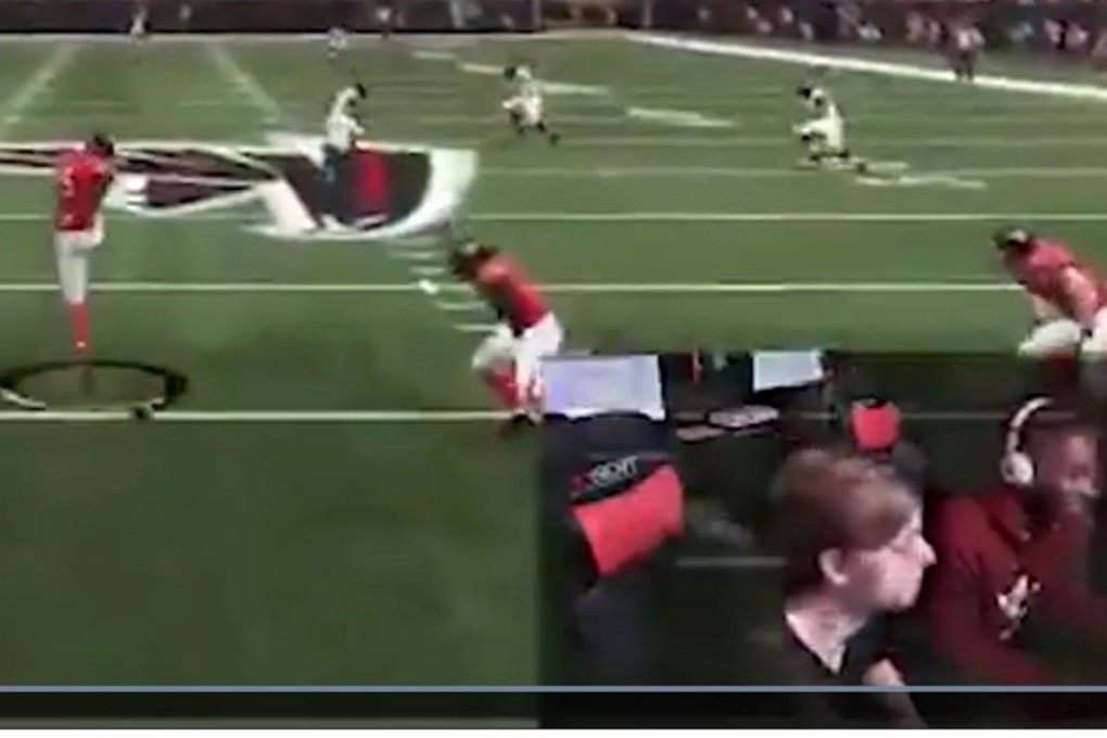 A red laser dot that appears to be a laser pointer is visible on the chest of player Eli Clayton (bottom right, wearing headphones) seconds before the first of a dozen gunshots rings out. Photo: Twitter