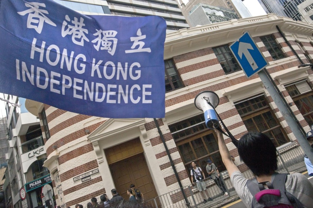 Demonstrators fly a banner for Hong Kong independence at the Foreign Correspondents’ Club, as a lunchtime talk is delivered by Andy Chan, convenor of the pro-independence Hong Kong National Party. Photo: EPA