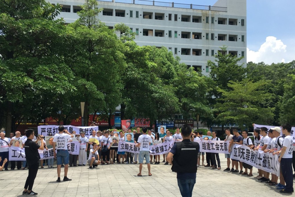 People hold banners at a demonstration in support of the factory workers at Jasic Technology. Photo: Reuters