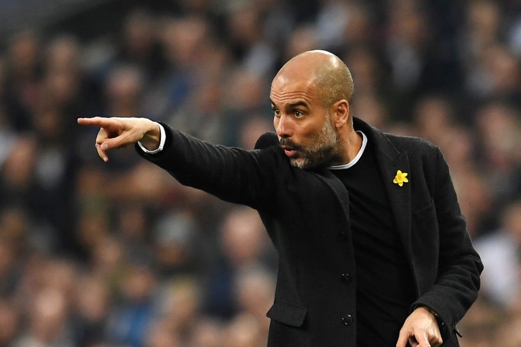 Manchester City manager Pep Guardiola sports a yellow ribbon during the English Premier League match against Tottenham Hotspur. Photo: EPA