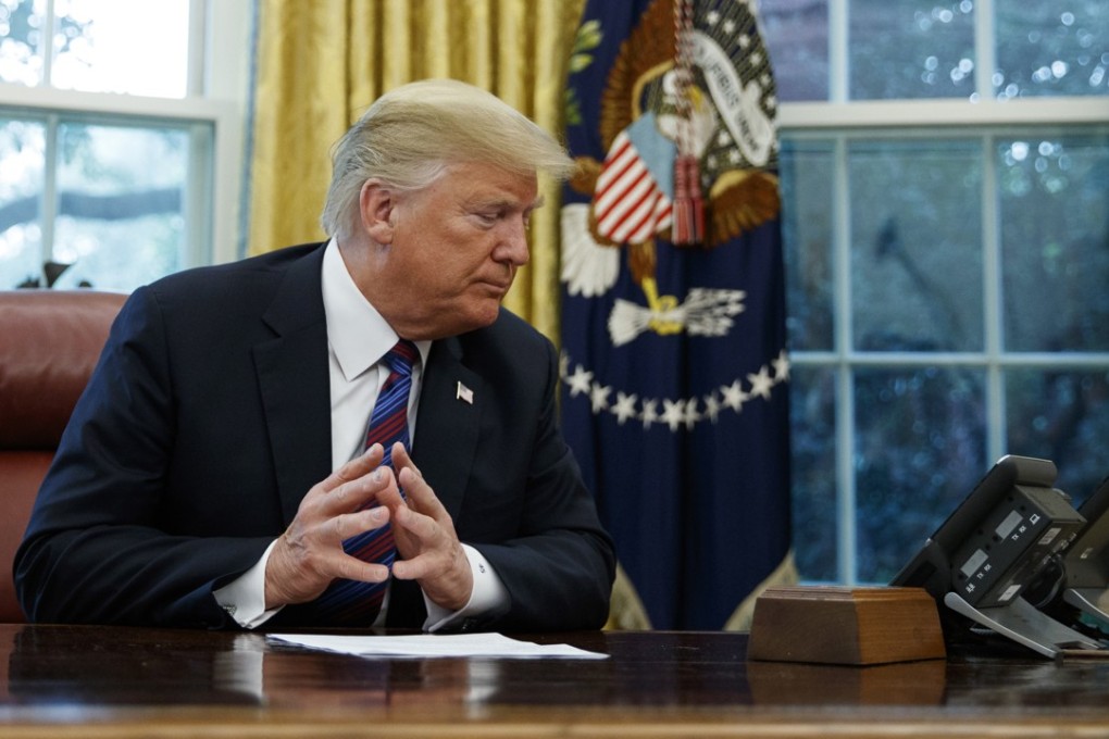 US President Donald Trump talks on the phone with Mexican President Enrique Pena Nieto. Photo: AP