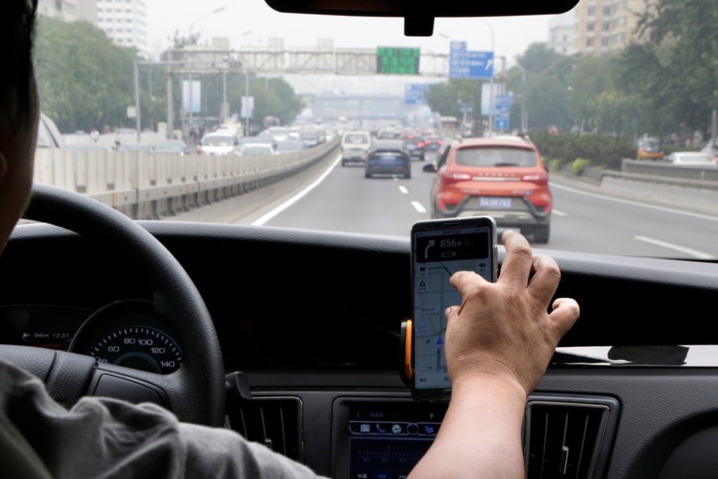 A Didi Chuxing driver rides his electric car on the way for service in Beijing. Photo: Reuters