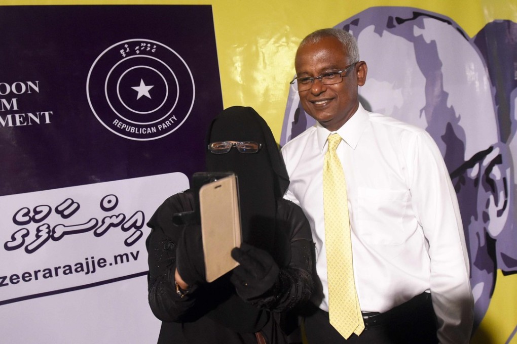 Maldives’ main opposition leader and presidential candidate Ibrahim Mohamed Solih poses for a selfie with a supporter. Photo: AFP