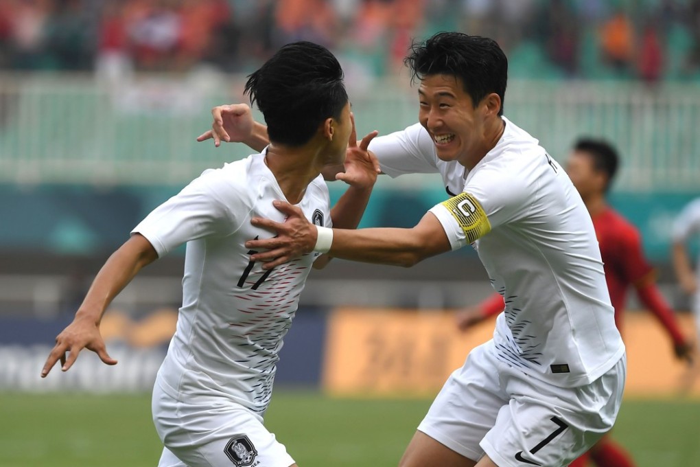 South Korea’s Lee Seung-woo (left) celebrates with teammate Son Heung-min after scoring during the Asian Games semi-final win over Vietnam. Photo: AFP
