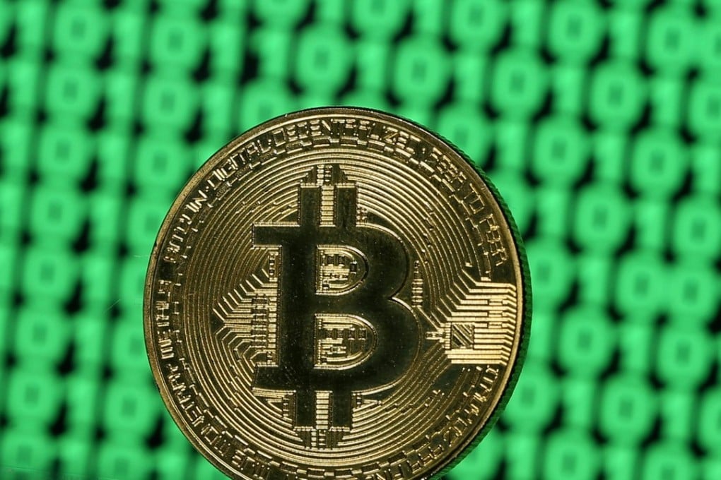 A token of the virtual currency Bitcoin is seen placed on a monitor that displays binary digits in this illustration picture. Photo: Reuters