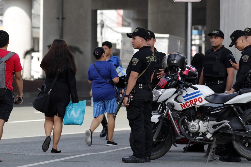Police stand guard on a street in Pasay City, south of Manila, on Wednesday. Photo: EPA