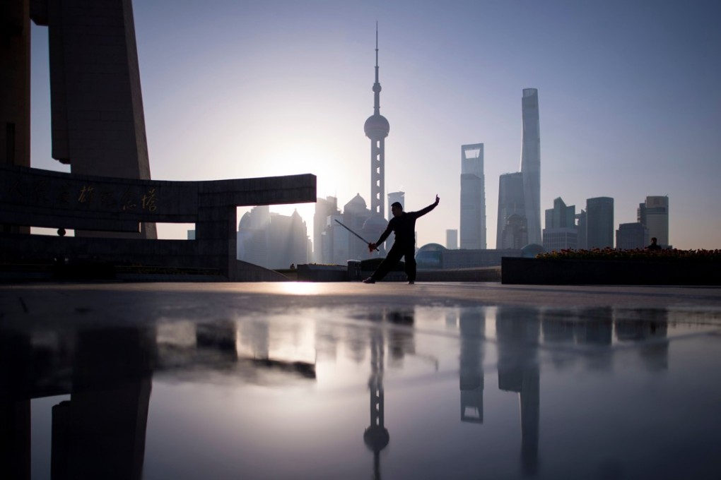 A man practises tai chi during sunrise at the Bund in Shanghai. Photo: AFP