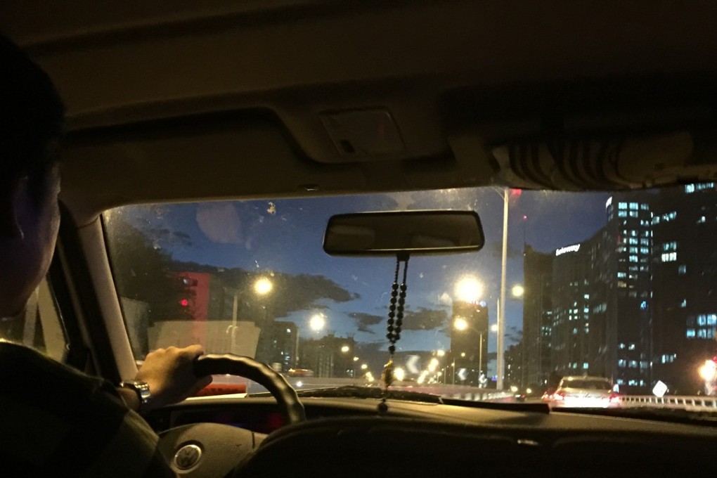 A private car owner who has registered 'didapinche', or 'dida pinche', a service allowing private car owners to give car pool service and accept fares, drives a passenger in Beijing. Photo: SCMP/Simon Song