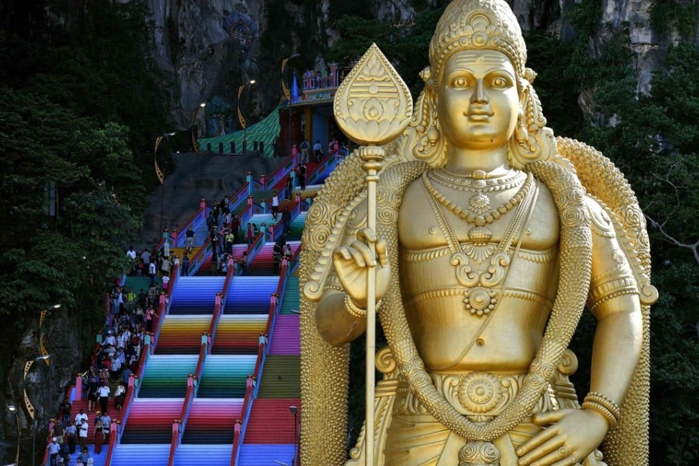 Visitors walk up the newly painted staircase leading to Malaysia's Batu Caves Hindu temple in Kuala Lumpur on August 30, 2018. Photo: AFP