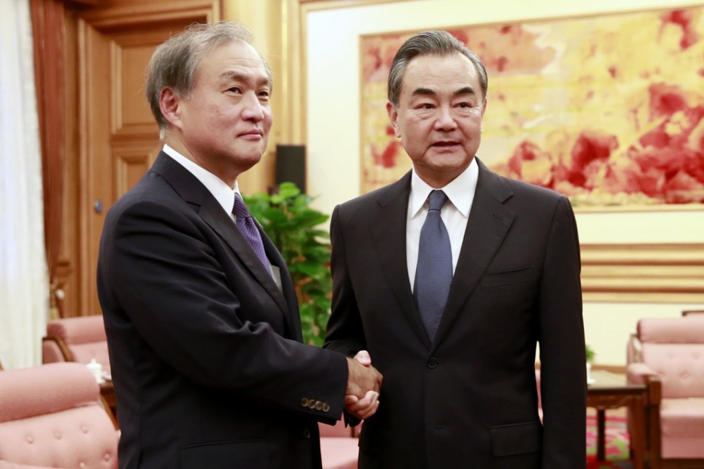 Beijing blocked a reporter from covering the meeting between Japanese Vice-Foreign Minister Takeo Akiba, left, and Chinese Foreign Minister Wang Yi. Photo: AP