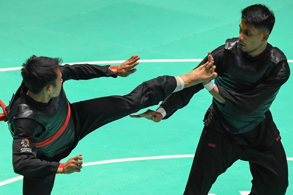 Malaysia’s 2016 world champion Mohd Al-Jufferi (right) takes on Indonesia’s Komang Putra in the men’s 65-70kg final. Photo: Xinhua