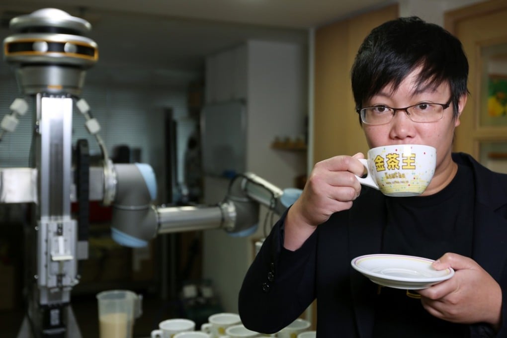 Karen Wong, vice-president of the Association of Coffee and Tea of Hong Kong, tasting a cup of milk tea made by robot KamChAI. Photo: Xiaomei Chen