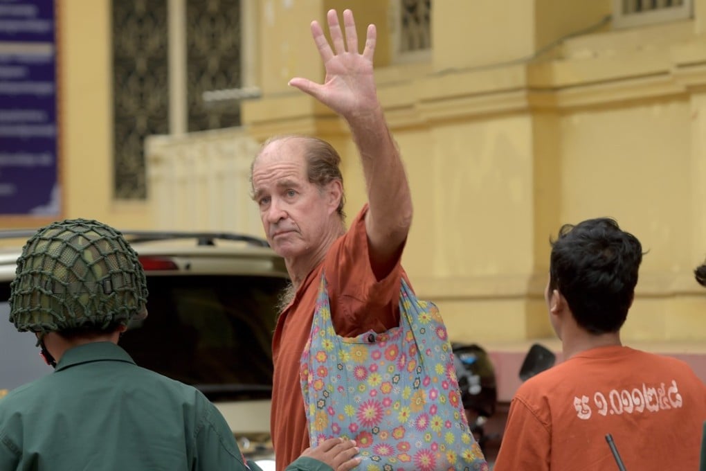 Australian James Ricketson gestures as Cambodian prison guards escort him to the Supreme Court for a bail hearing in Phnom Penh on January 17. He was sentenced to six years for allegedly spying on Cambodia of ‘foreign states’. Photo: AFP