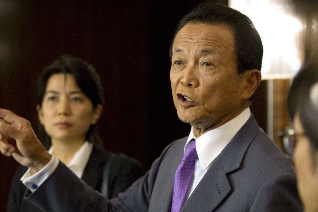Japan's Finance Minister Taro Aso speaks to the media after a meeting with his Chinese counterpart Liu Kun. Photo: AP