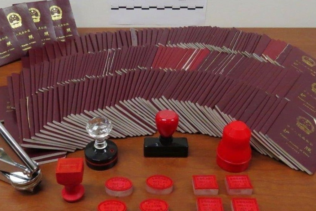 Some of the hundreds of Chinese passports, along with fake Chinese passport stamps, that were seized from the home and offices of former unlicensed immigration consultant Xun “Sunny” Wang, by Canadian border officers in raids across greater Vancouver on October 17, 2012. Photo: Canada Border Services Agency