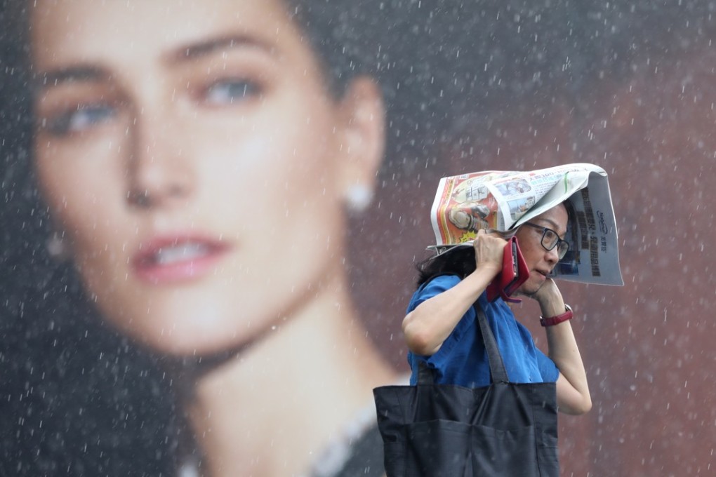 A woman walking in the rain in Tsim Sha Tsui. Photo: Edward Wong