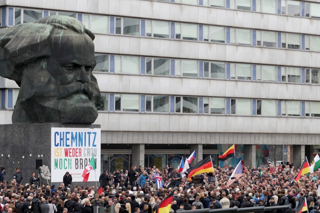 People attending a demonstration of the right-wing group “Pro Chemnitz” in front of the Karl Marx memorial in Chemnitz, Germany, on Saturday. Right-wing groups called for several demonstrations on the weekend after two refugees from Syria and Iraq were arrested on suspicion of stabbing a 35-year-old man in Chemnitz. Photo: EPA-EFE