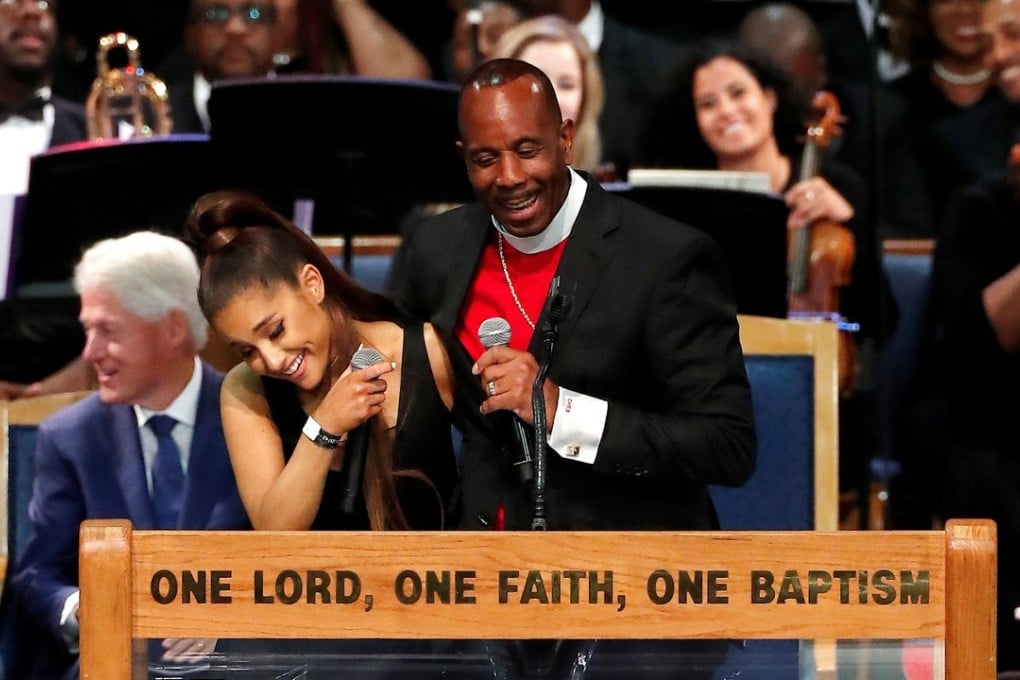 Pastor Charles Ellis with the singer Ariana Grande after she performed at the funeral service for Aretha Franklin at the Greater Grace Temple in Detroit, Michigan, on Friday. Former US President Bill Clinton is in the background. Photo: Reuters