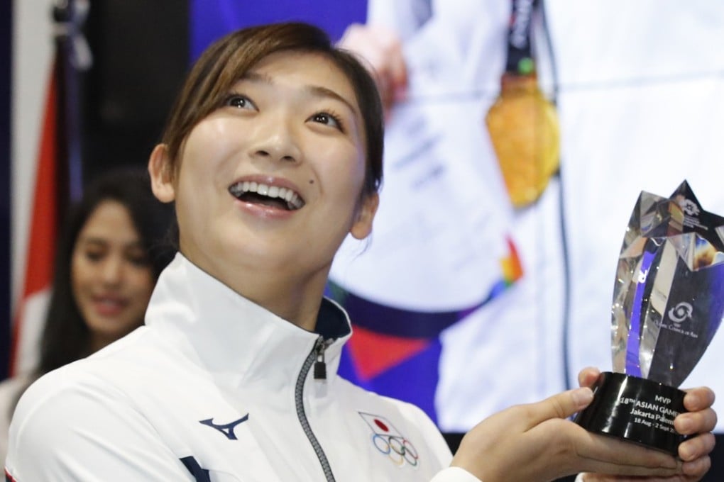 Japanese swimmer Rikako Ikee poses with the Asian Games MVP trophy. Ikee won six gold medals in swimming. Photo: Kyodo