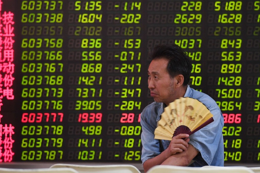 Stock prices are displayed at a securities company in Beijing. All the 3,000-plus companies on the mainland’s exchanges posted an average of 14.1 per cent earnings growth in the second quarter. Photo: AFP