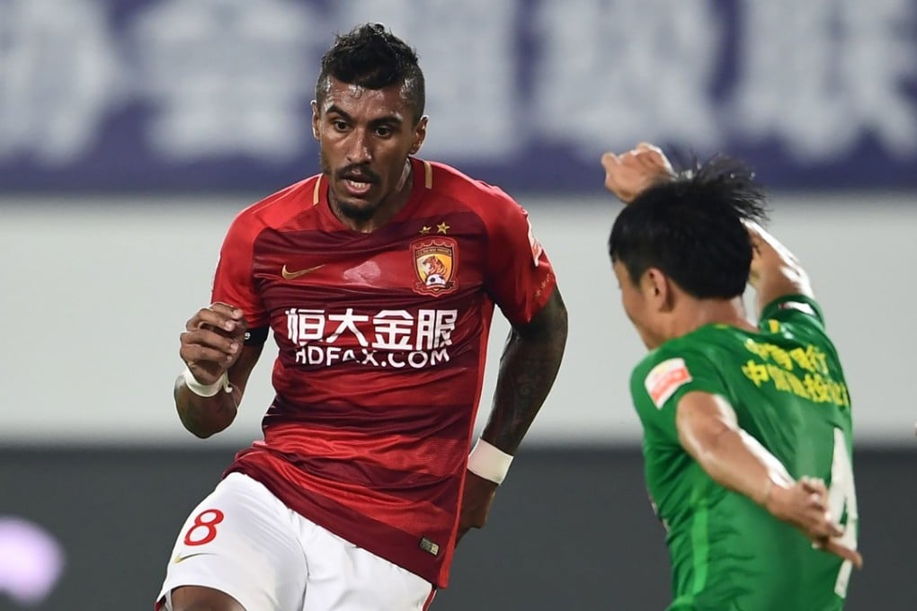 Paulinho of Guangzhou Evergrande in action with Li Lei of Beijing Guoan in their Chinese Super League match. They meet again on September 14. Photo: AFP