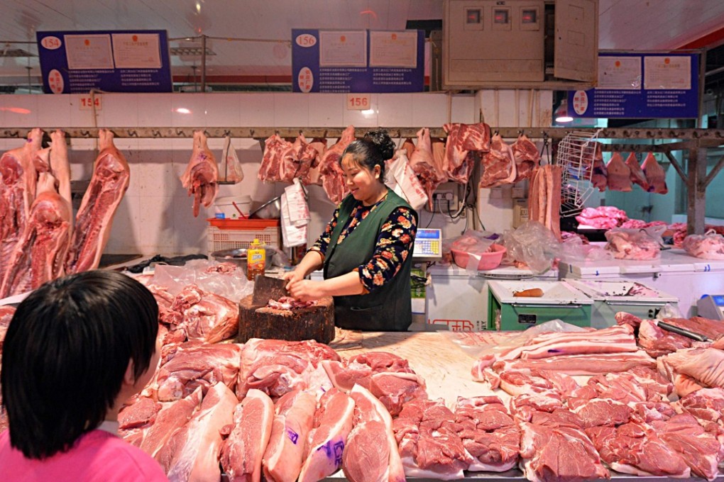 A butcher prepares slabs of pork in Beijing. Photo: AFP