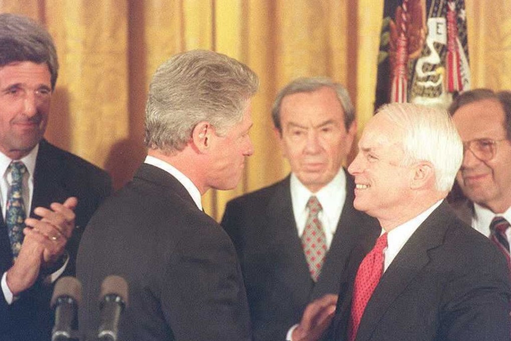 Then US president Bill Clinton (second left) talks to senator John McCain at the White House in 1995, after announcing the establishment of normal relations with Vietnam. Photo: AFP