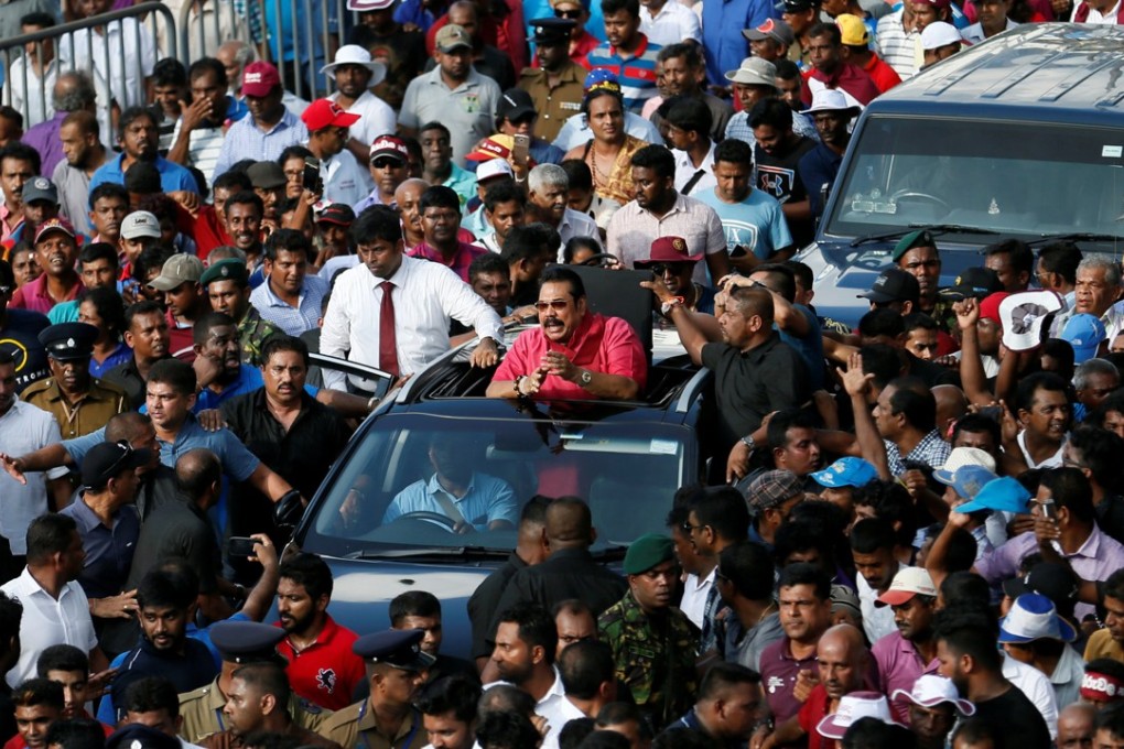 Former Sri Lankan President Mahinda Rajapaksa, who leads the country's joint opposition, waves at his supporters during an anti-government protest in Colombo, Sri Lanka. Photo: Reuters