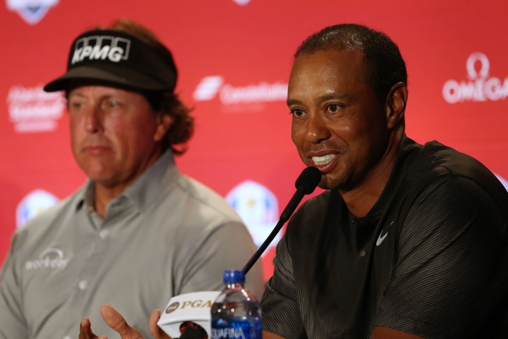 Tiger Woods speaks after being chosen along with Phil Mickelson (L) as Captain's Picks by US Ryder Cup team captain Jim Furyk. Photo: AFP